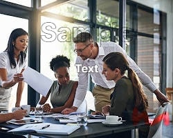 Four diverse colleagues collaborating around a conference table in a modern office setting.